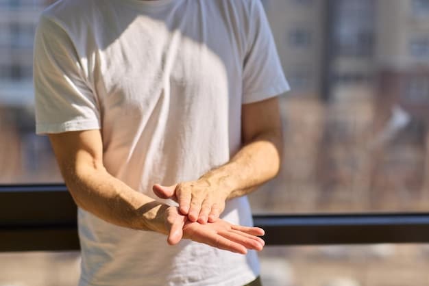 A close-up of hands performing a wrist stretch, highlighting the muscles and tendons being engaged. The background is blurred, emphasizing the focus on the stretch.