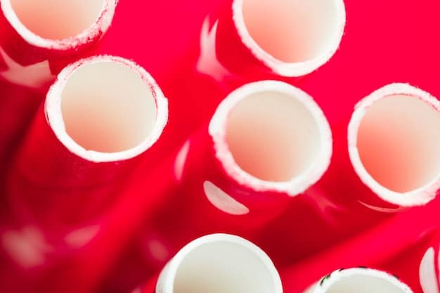 A close-up photograph of two types of penile implants: one inflatable with multiple components (cylinders, reservoir, pump), and one malleable, illustrating their different designs and materials used in each.