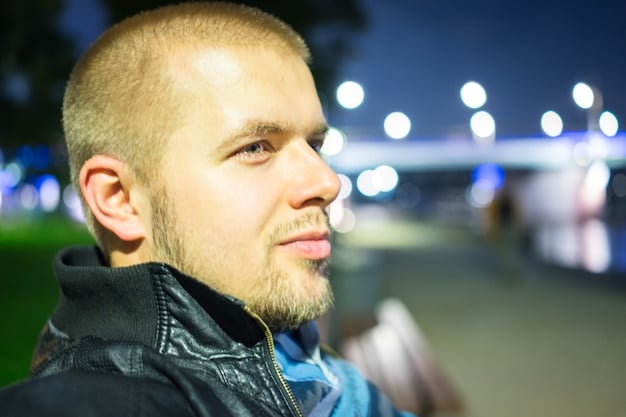 A close-up of a man with a faded buzz cut, showcasing a smooth transition from short hair on top to even shorter hair on the sides, highlighting the clean lines and simplicity of the cut.
