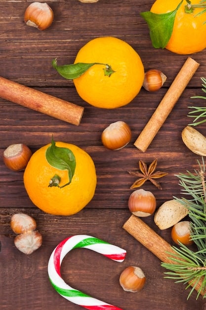 A close-up shot of various fragrance ingredients, including citrus fruits, spices, and aromatic herbs, carefully arranged to represent the different layers of a cologne's scent profile.
