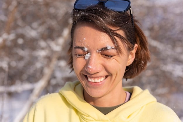 A person applying sunscreen to their face before heading out for a winter activity. The focus is on the importance of sun protection even in cold weather.