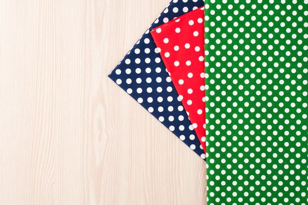 A flat lay featuring a variety of ties showcasing different patterns, including stripes, polka dots, paisley, and geometric designs. The background is a neutral fabric to highlight the details of each pattern.