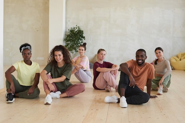 A diverse group of men are seated comfortably on yoga mats in a sunlit studio, participating in a guided meditation session. They have their eyes closed, with peaceful and relaxed expressions. The instructor is gently guiding them through the exercise.