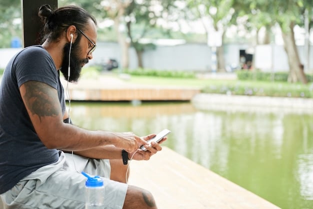 A man using a mindfulness app on his phone while sitting on a park bench. He has a focused and peaceful expression. The app interface is visible, showing a guided meditation session. Soft, natural light. Blurry background of the park.