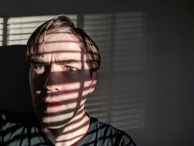 A close-up of a man's face, partially shadowed, with a concerned expression. The background is blurred, emphasizing his internal struggle.