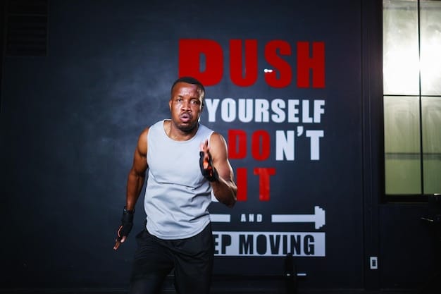 A man smiling while lifting weights in a gym, with motivational posters in the background, focused on strength and determination.