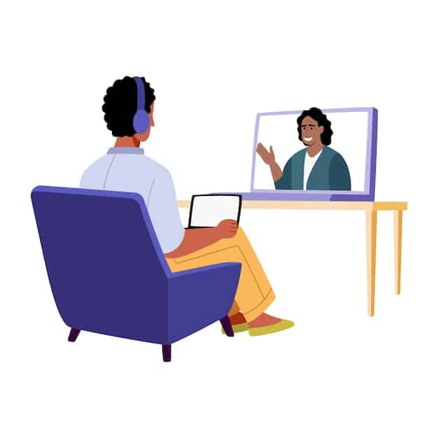 A man engaged in a telehealth therapy session, talking openly to a therapist on a laptop screen. The man is in a comfortable home environment, seated on a couch, while the therapist appears professional and attentive on the screen.