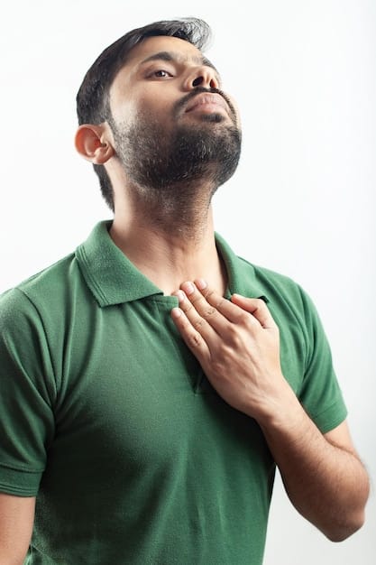 A close-up of a man taking deep breaths, eyes closed, and hand on his chest, focusing on conscious breathing as a calming technique. Soft, diffused light enhances the peaceful, introspective atmosphere.