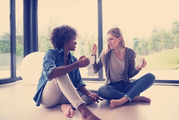 Two people sitting face to face, one actively listening while making eye contact, the other person speaking with a calm and open expression.