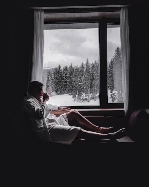A person sleeping peacefully in a dark room, with the moonlight shining through the window.