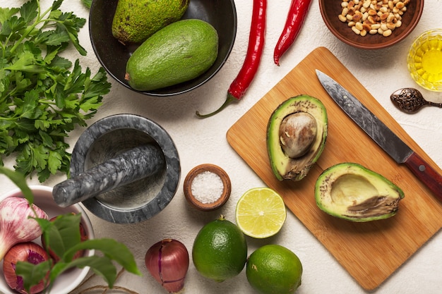 A flat lay of various libido-boosting foods including oysters, dark chocolate, avocados, and chili peppers arranged on a rustic wooden surface. The composition is artful and inviting, highlighting the natural colors and textures of the ingredients.