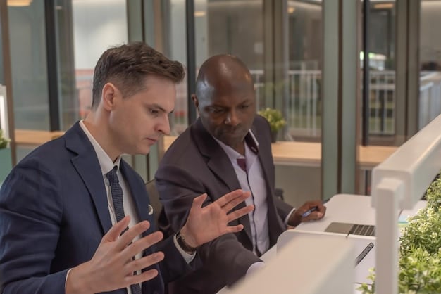 Two professionals engaged in a focused discussion in a modern office, one speaking and the other listening intently, exemplifying effective communication in a negotiation setting.