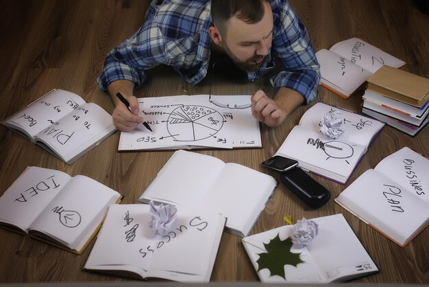 A person sitting at a desk, looking thoughtful, with a mind map or brainstorming notes visible, symbolizing strategic planning and narrative development.