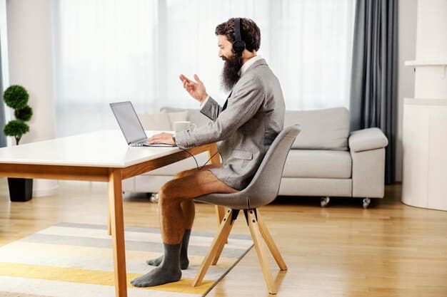 A person sitting upright and leaning slightly forward, maintaining an engaged and attentive posture during a virtual meeting.