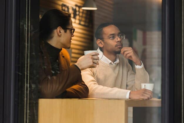 Two individuals engaged in a dynamic, face-to-face conversation in a modern cafe setting, with open notebooks and coffee cups on the table, illustrating an engaging informational interview.