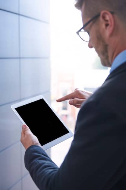 A professional with a thoughtful expression using a stylus on a tablet, with AI-generated text suggestions appearing subtly on the screen. The background is a clean, modern office setting.