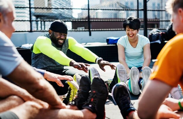 A diverse group of people engaged in various fitness activities in an open, modern community center, emphasizing inclusivity and varied training methods.
