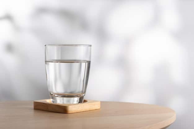 A clear glass of water next to a hand-written note saying 
