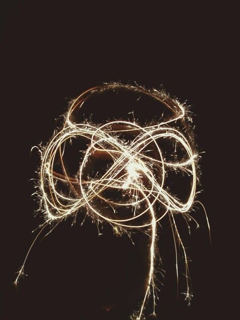 A brain graphic with neurons lighting up, symbolizing increased cognitive function, alongside miniature weights representing physical strength, illustrating creatine's dual benefits.
