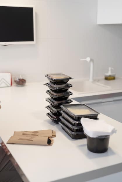 A sleek, modern kitchen counter showcasing various meal prep tools, including a high-speed blender, an Instant Pot, and stackable glass containers, emphasizing organization and efficiency.