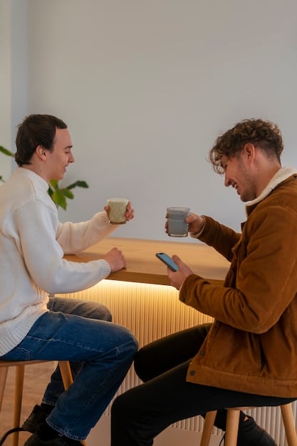 Two men having a calm, open conversation over coffee, signifying improved communication and conflict resolution.