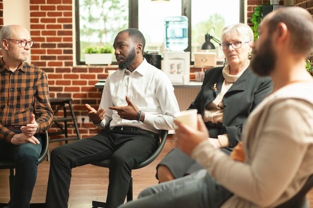 A diverse group of men participating in a support group session, seated in a circle, engaged in open discussion. The atmosphere is empathetic and confidential.