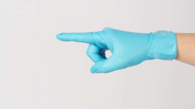 A close-up, respectful and clinical image of a hand wearing a medical glove pointing to a discreet lesion or symptom on the skin, illustrating the subtle presentation of syphilis, with medical instruments blurred in the background.