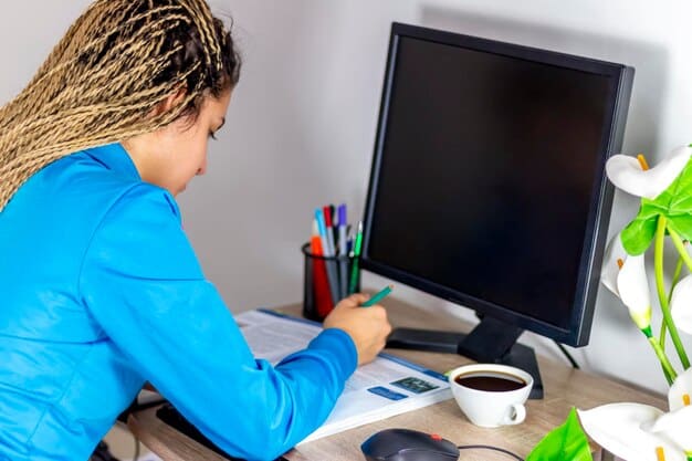 A person sitting calmly at a desk, looking at a computer screen with medical information, taking notes, symbolizing preparation and research before a difficult conversation.