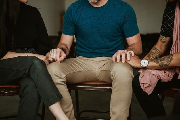 A supportive and empathetic image of a diverse group of men participating in a prostate cancer support group, showing open discussion and mutual support. The environment should be comforting and inclusive.