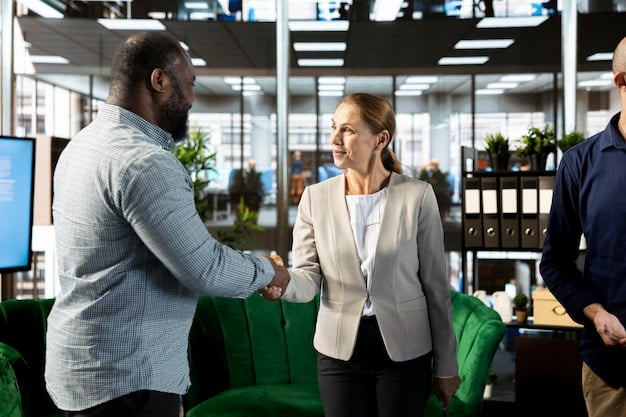 A person confidently shaking hands with another professional at a networking event. The focus is on the handshake, symbolizing trust and connection. There are blurred figures in the background, indicating a lively networking atmosphere.