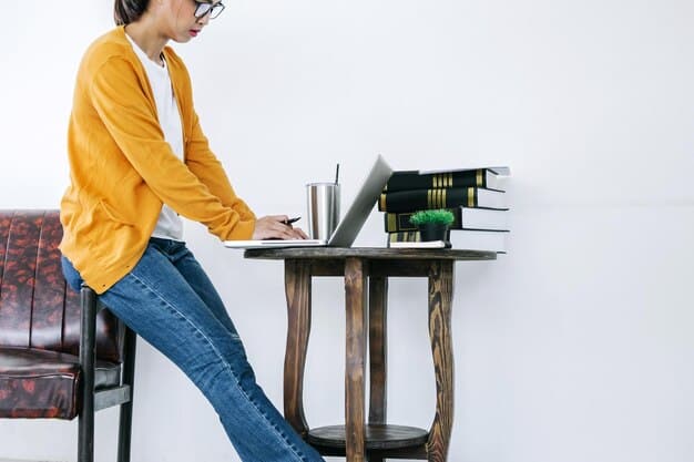 A person sitting at a desk, focused on a laptop, with books and notepads surrounding them, highlighting the importance of continuous learning. The scene illustrates a strategy from The Ultimate Guide to Career Advancement: Strategies for Getting Promoted in 2025.