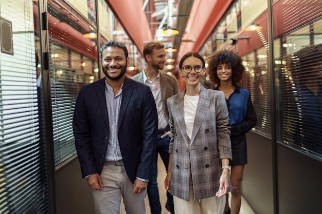 A group of diverse professionals standing together, smiling, in a modern office lobby. One person is slightly in front, gesturing with their hand as if they are leading or guiding the group. This visually represents The Power of Mentorship: Find a Mentor, Become a Mentor, and Accelerate Your Career Growth for a group of people.