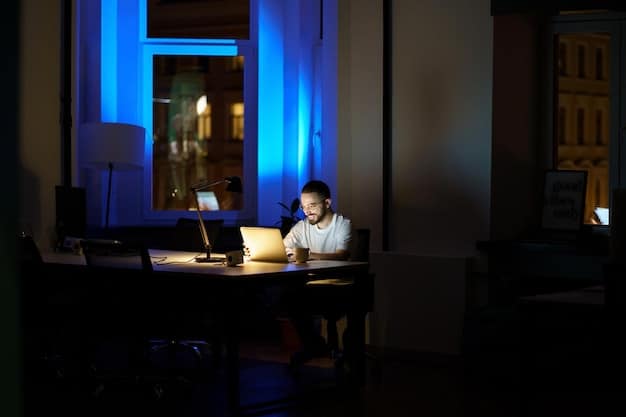 An employee is seen working late at the office, illuminated by the soft glow of a computer screen, with city lights visible through a window. The scene portrays the dedication and potential impact of overtime work, relevant to discussions about understanding the new overtime rules in 2025.