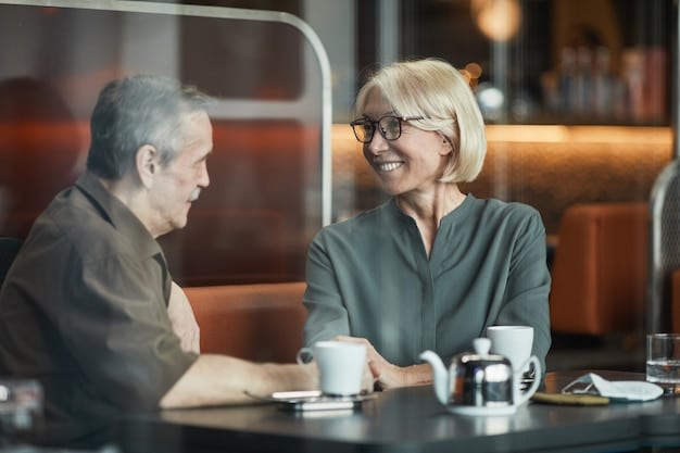 Two professionals in a coffee shop, engaged in a deep conversation. One is an older, experienced person gesturing thoughtfully, while the other is a younger person listening intently and taking notes. The setting is relaxed and informal, symbolizing a supportive and engaging mentoring session.
