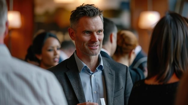 A young professional confidently approaching a senior executive at a networking event. The executive is smiling and holding out a business card. The scene portrays a proactive and confident approach towards building new connections and seeking mentorship opportunities in a professional setting.