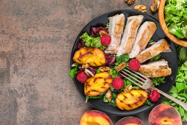 A flat lay image of a variety of healthy foods, including grilled chicken breast, broccoli, avocado, almonds, and a glass of water, symbolizing the ideal nutrient-rich diet to follow during the 8-hour eating window of the 16/8 method for men. The image represents 'Intermittent Fasting for Men: The Complete 16/8 Method Guide for 2025'.
