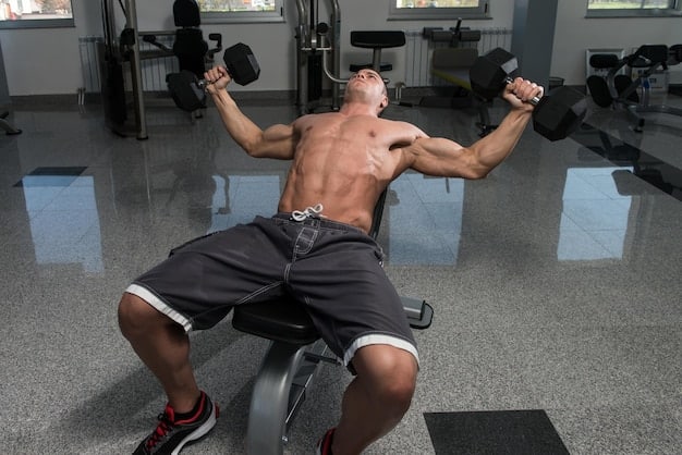 A person doing crunches inside of a gym with sport equipment. The body is rising from the floor while arms are over the head.
