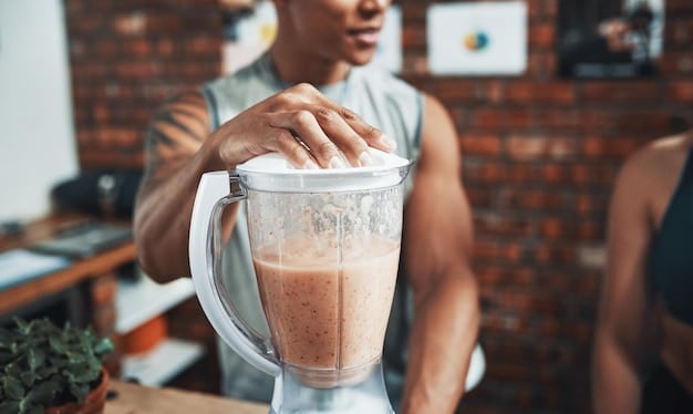 A close-up shot of a person preparing a protein smoothie with various fruits, protein powder, and a blender in a modern kitchen. The focus is on the ingredients and the blending process, highlighting the ease and appeal of a quick high-protein breakfast option.