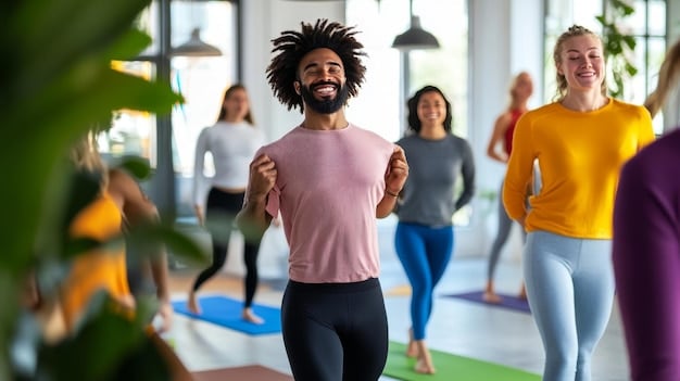 A person smiling while participating in a Zumba class, surrounded by other enthusiastic participants, illustrating the fun and social aspect of group fitness activities.