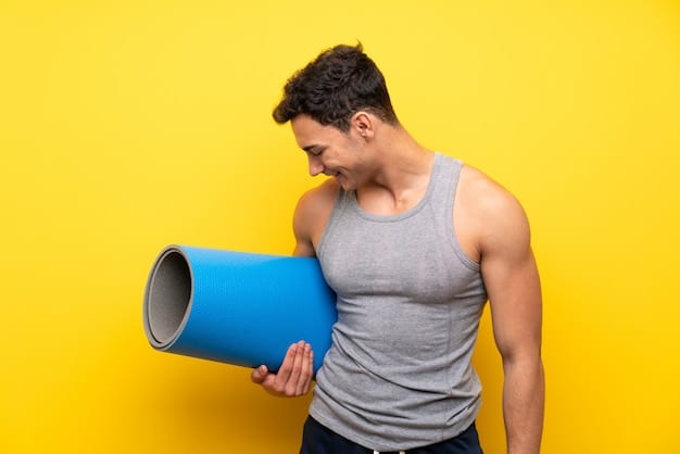 A male athlete using a foam roller on his quadriceps. He is grimacing slightly, indicating the pressure and effectiveness of the foam rolling. The environment is a well-lit and equipped fitness studio. This emphasizes the use of tools like foam rollers as part of The Best Post-Workout Recovery Strategies for Men in 2025.
