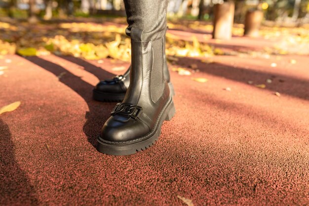 A close-up of running shoes hitting a paved path, emphasizing the importance of proper footwear for preventing injuries when Running for Weight Loss: The Ultimate Beginner's Guide. The shoelaces are brightly colored, and the background is slightly blurred.
