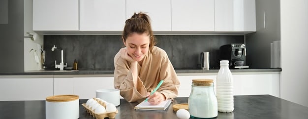A person is sitting at a kitchen table with a notebook and pen, carefully planning meals for the week. The notebook is open to a page with handwritten recipes and a grocery list. Scattered around are cookbooks, recipe printouts, and various food magazines. The scene conveys thoughtful preparation and organization.