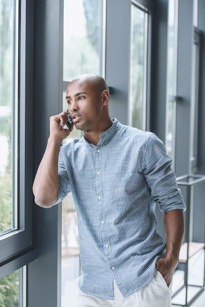 An image of a man speaking confidently on the phone, with a supportive and empathetic expression on his face. The background shows a calm and comforting environment, symbolizing the supportive nature of the 988 hotline.