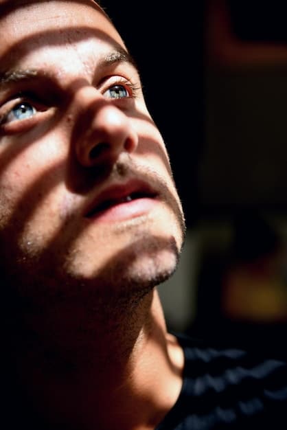 A close-up shot of a man's face, conveying a sense of deep thought and introspection, with a slight shadow over his eyes, symbolizing the hidden struggles men often face. Relevant to the discussion of '5 Proven Strategies to Reduce Male Suicide Risk by 15% in the Next Year'.