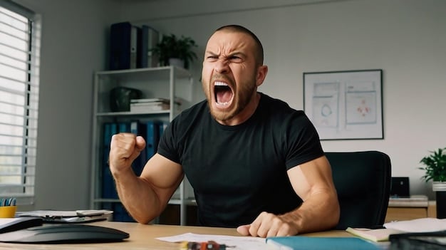 A man clenching his fists in frustration while sitting at a desk, symbolizing uncontrolled anger and the need for Anger Management for Men: 3 Techniques to Regain Control in 30 Days.