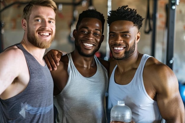 A diverse group of men participating in a group fitness class, smiling and encouraging each other. The setting is a brightly lit gym with various exercise equipment visible in the background, capturing a positive and supportive environment.