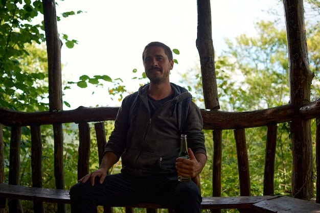 A man meditating in a serene outdoor setting, with trees and sunlight filtering through the leaves in the background. He's sitting cross-legged on a yoga mat, embodying mindfulness and tranquility achieved through exercise and meditation.