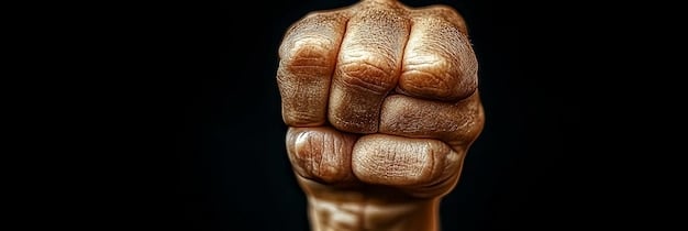 A close-up shot of a clenched fist, symbolizing determination and inner strength. The background is blurred, emphasizing the focus on resilience and mental toughness. The image is relevant to Building Resilience: 5 Mental Toughness Strategies for Men in 2025.