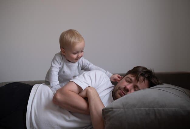 A new father sitting on the edge of his bed, looking exhausted and isolated. He's surrounded by baby supplies, and the room is dimly lit. The image captures the feelings of loneliness and overwhelm that can contribute to postpartum depression in men. The Updated Guide to Managing Male Postpartum Depression: Symptoms, Support, and Treatment Options Available in the US.