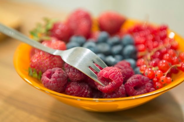 A close-up shot of a plate filled with colorful, fertility-boosting foods such as salmon, blueberries, walnuts, and spinach, representing a diet rich in antioxidants and essential nutrients for improving sperm health and 